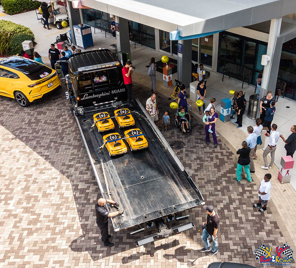Yellow mini Lamborghini Urus cars arrive at Joe DiMaggio’s Children’s Hospital