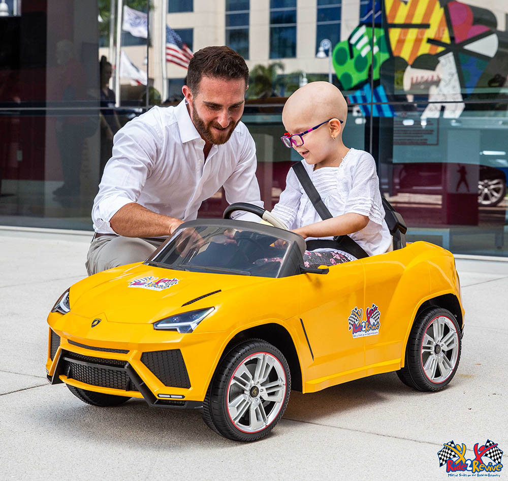 Brett David with one of the kids and the Mini Lamborghini 